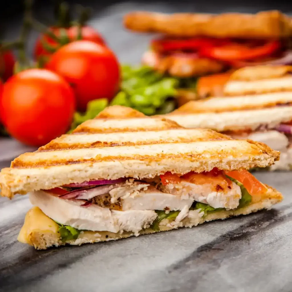 a sandwich with tomatoes and lettuce