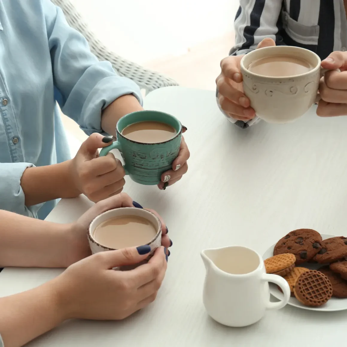 a group of people holding cups of cafe au lait