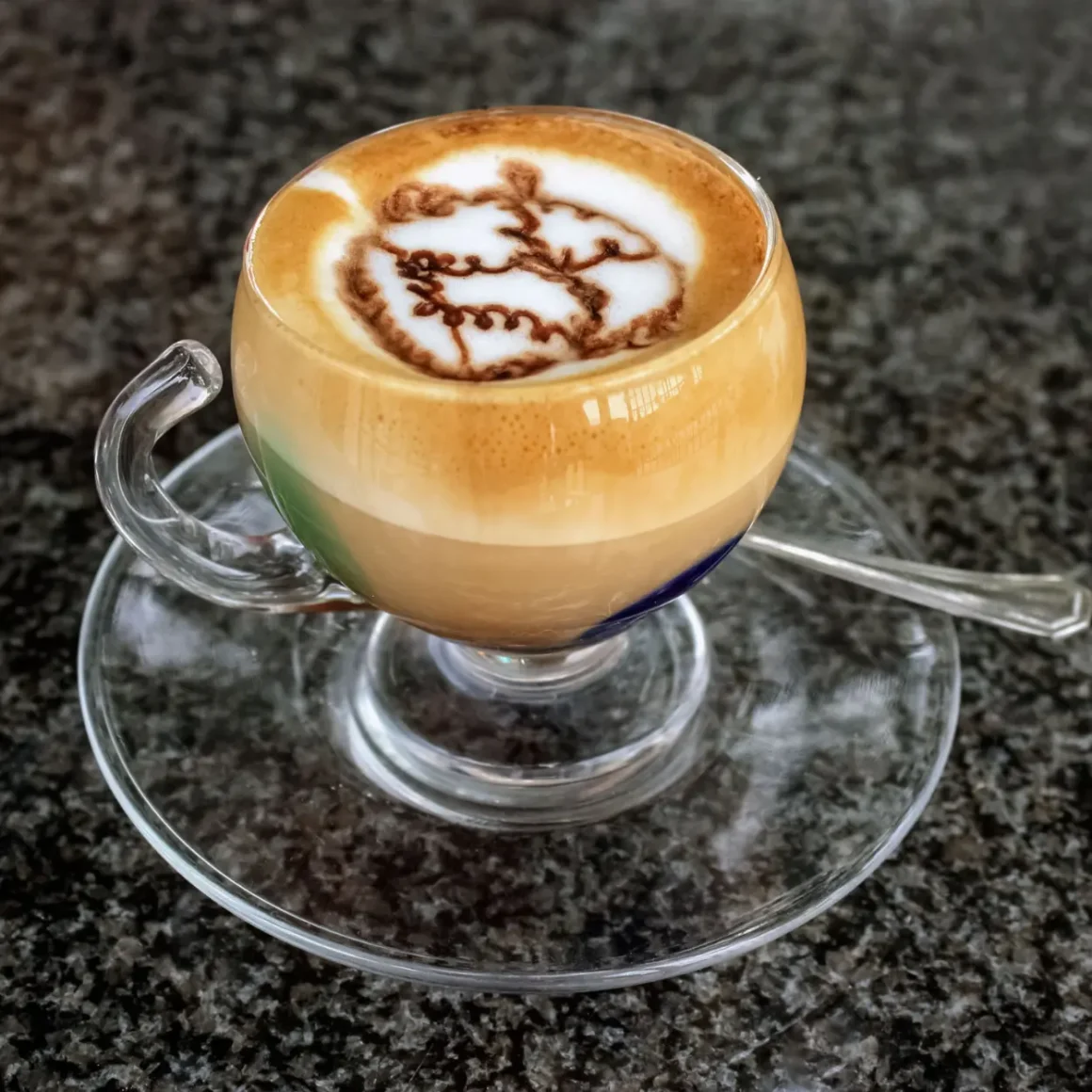 a glass cup with marocchino coffee in it