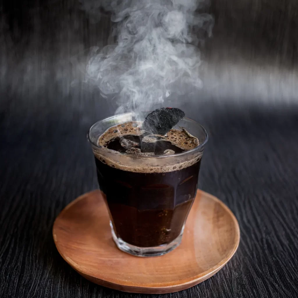 a glass of charcoal coffee