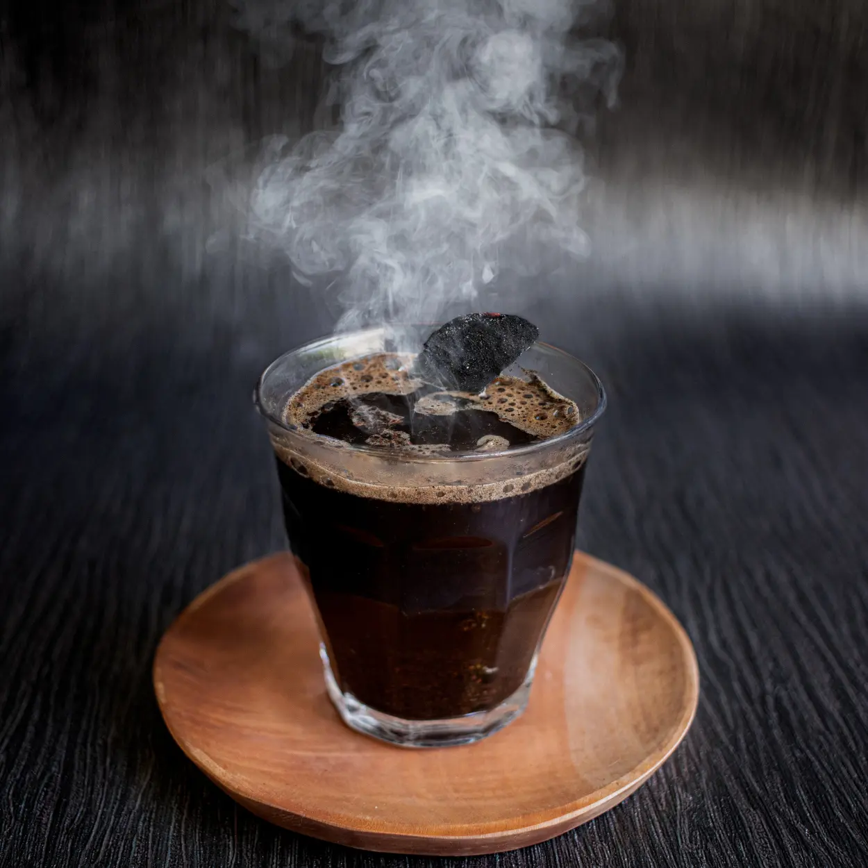 a glass of charcoal coffee