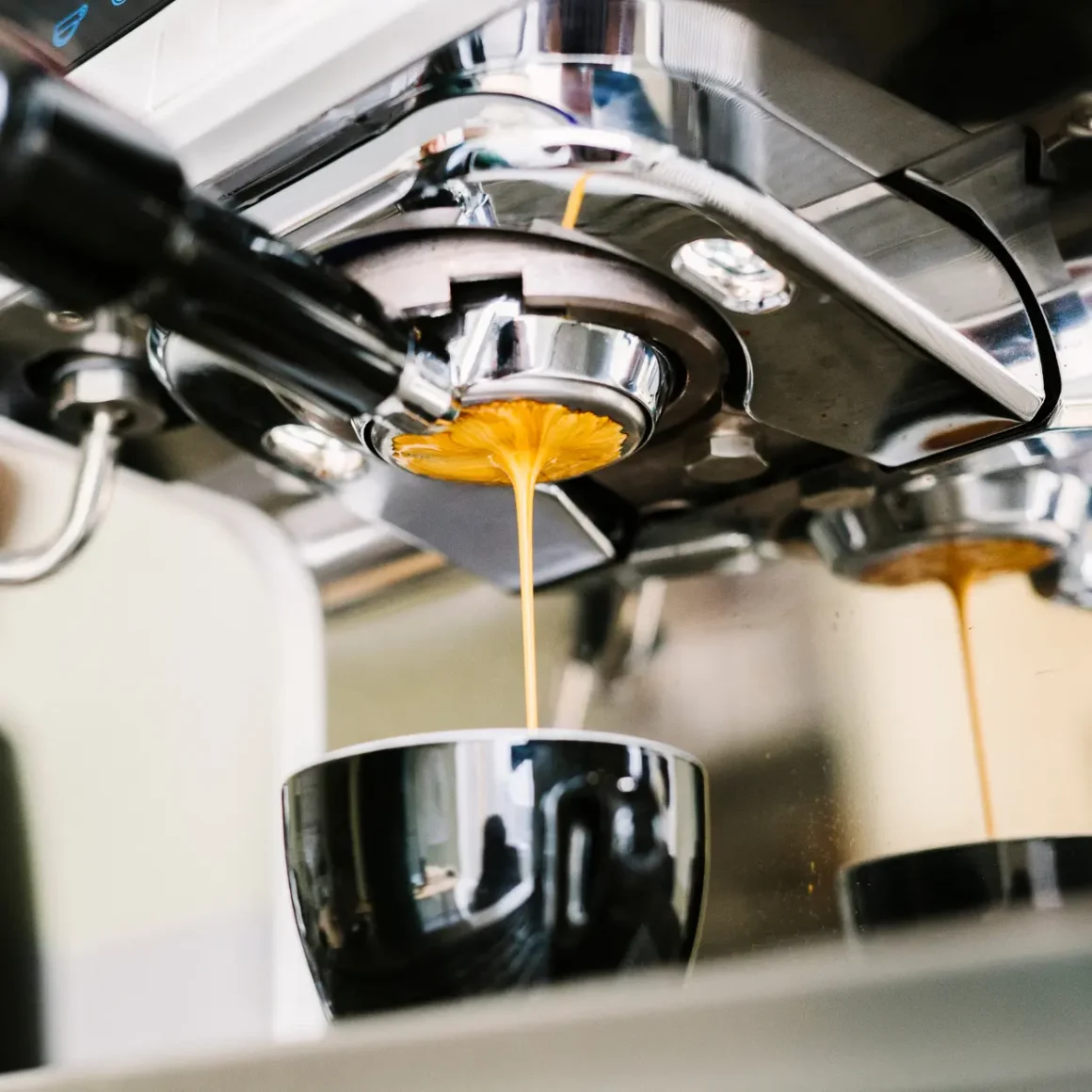 a coffee machine pouring a coffee into a cup