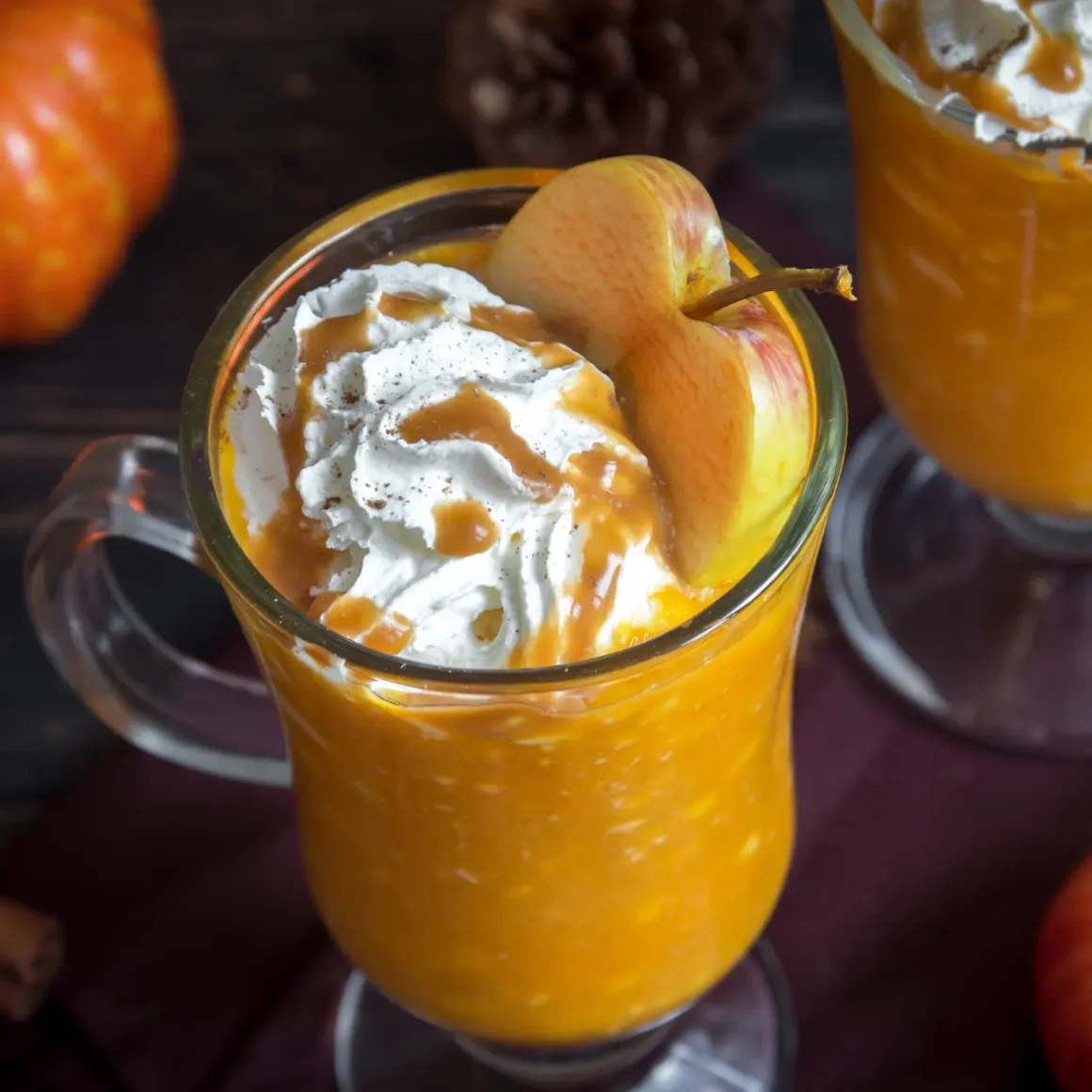 a glass mug with a caramel apple cider coffee