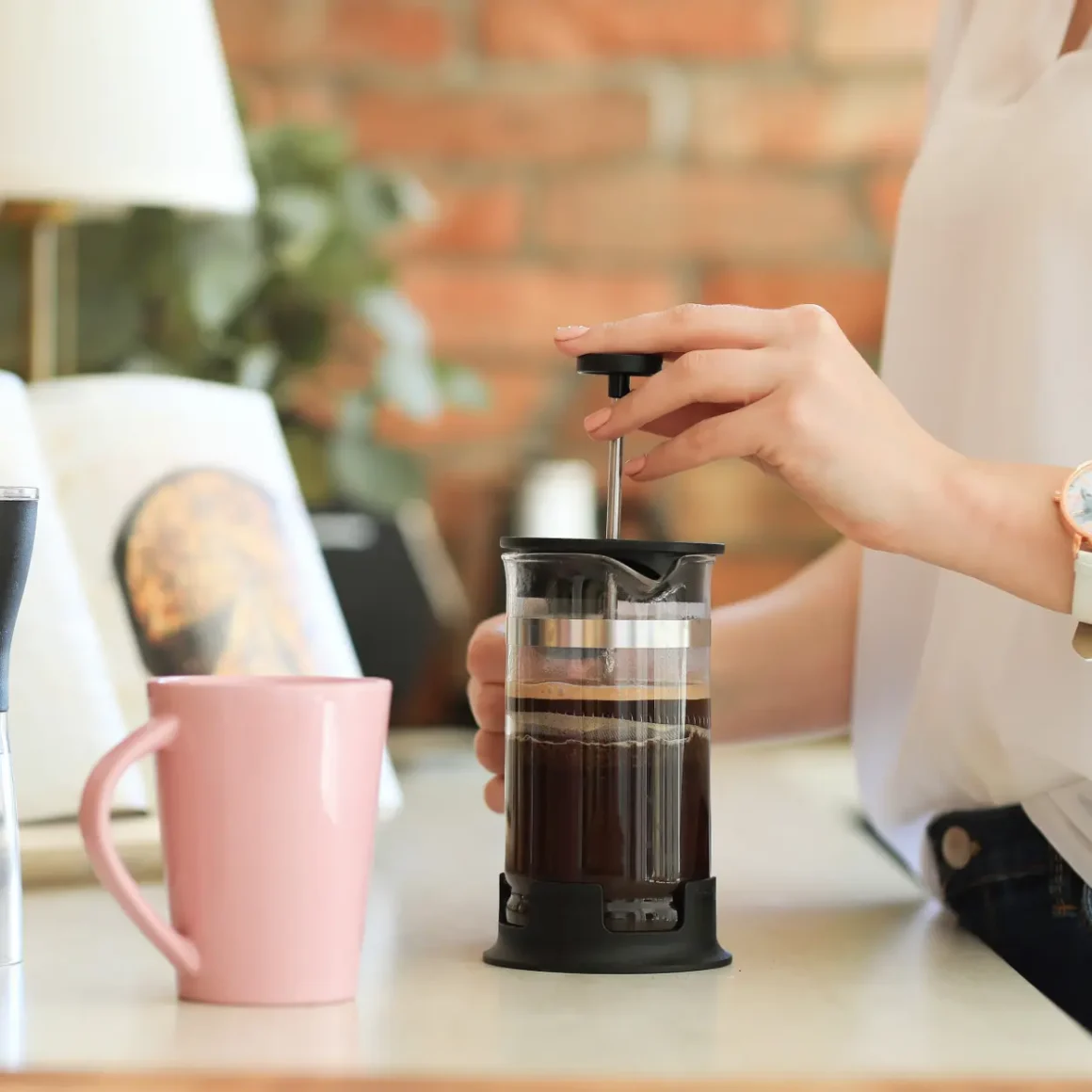 a person using a coffee press