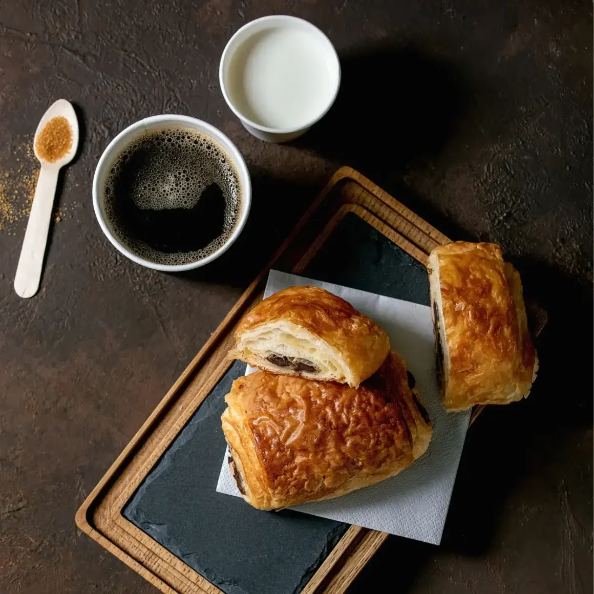 a pastry and cups of coffee