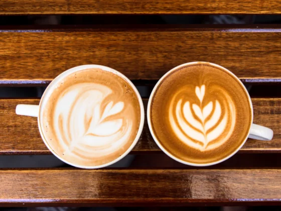 a cup of cappuccino and latte on a table