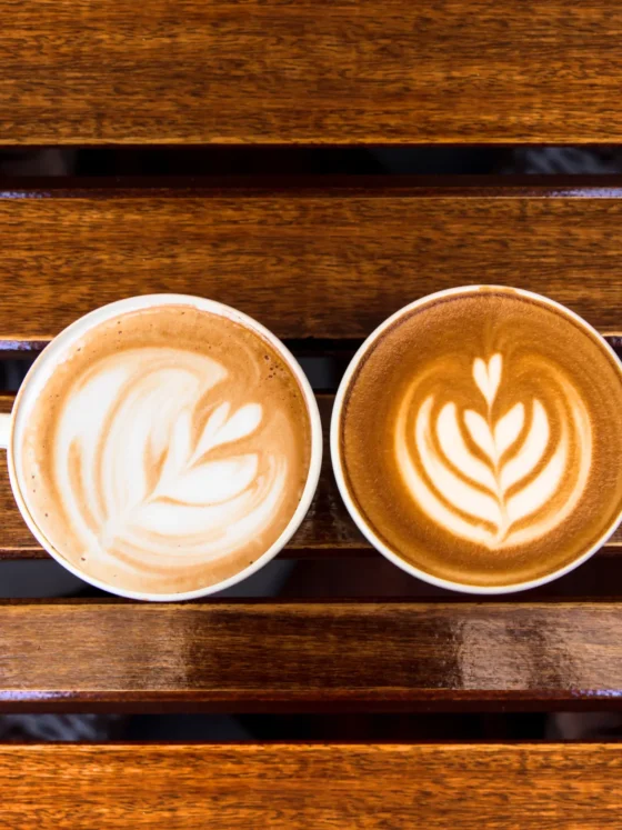 a cup of cappuccino and latte on a table