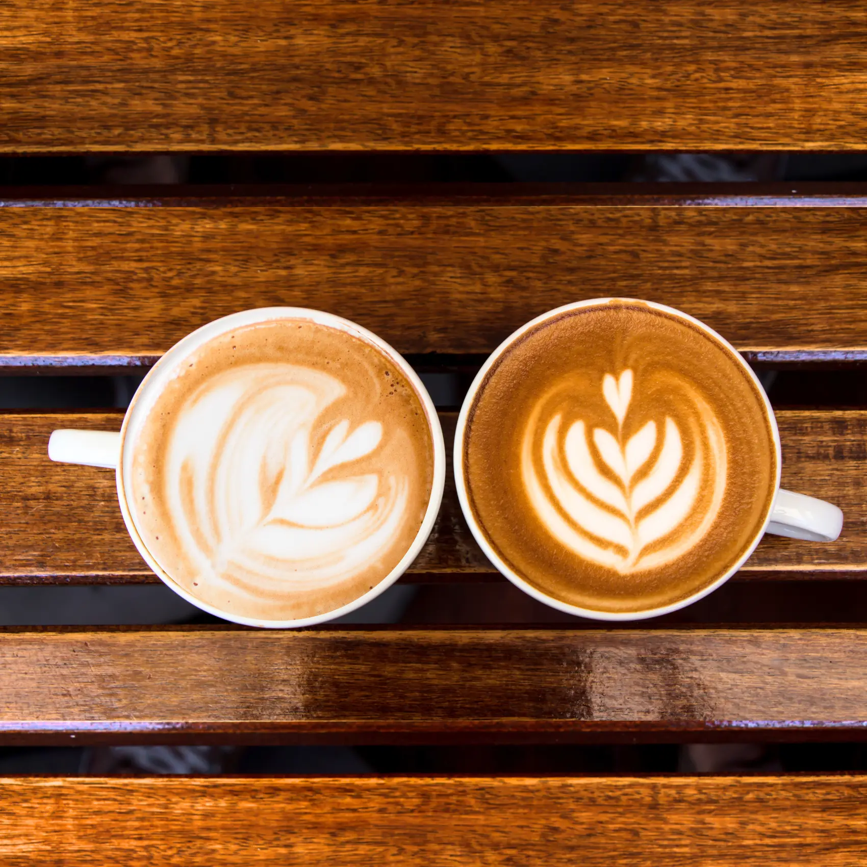 a cup of cappuccino and latte on a table