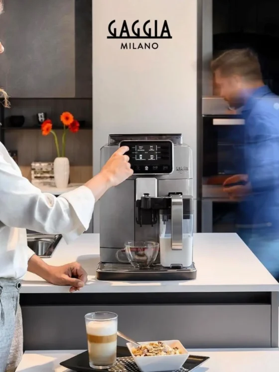 a person standing in front of Gaggia Cadorna Prestige coffee machine