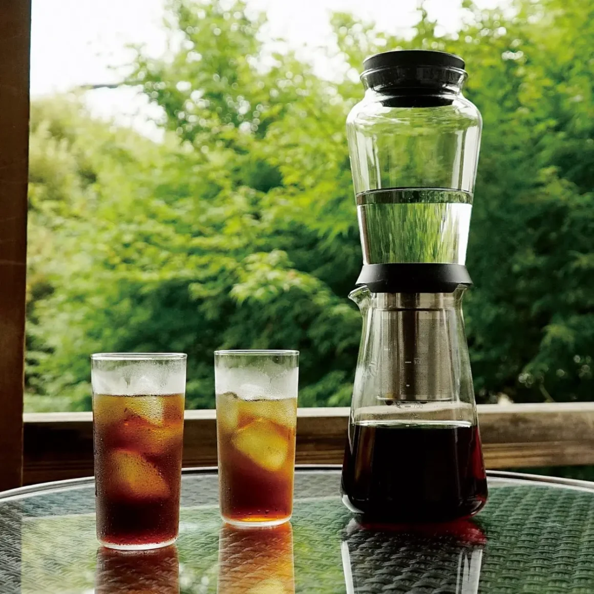 hario slow drip brewer and two glasses of coffee on a table