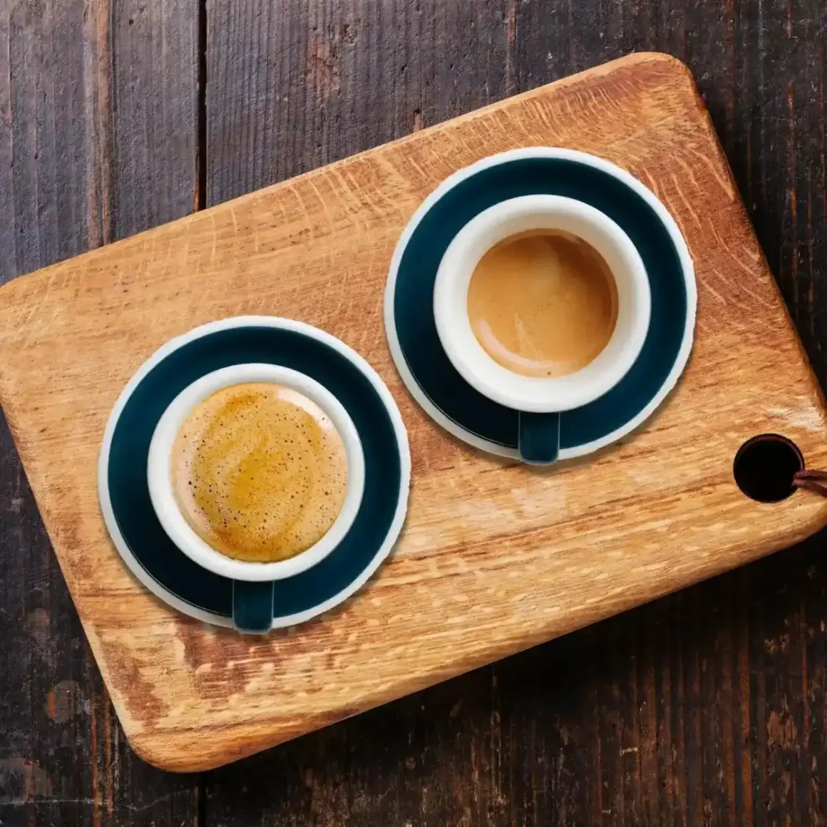 two cups of coffee on a cutting board