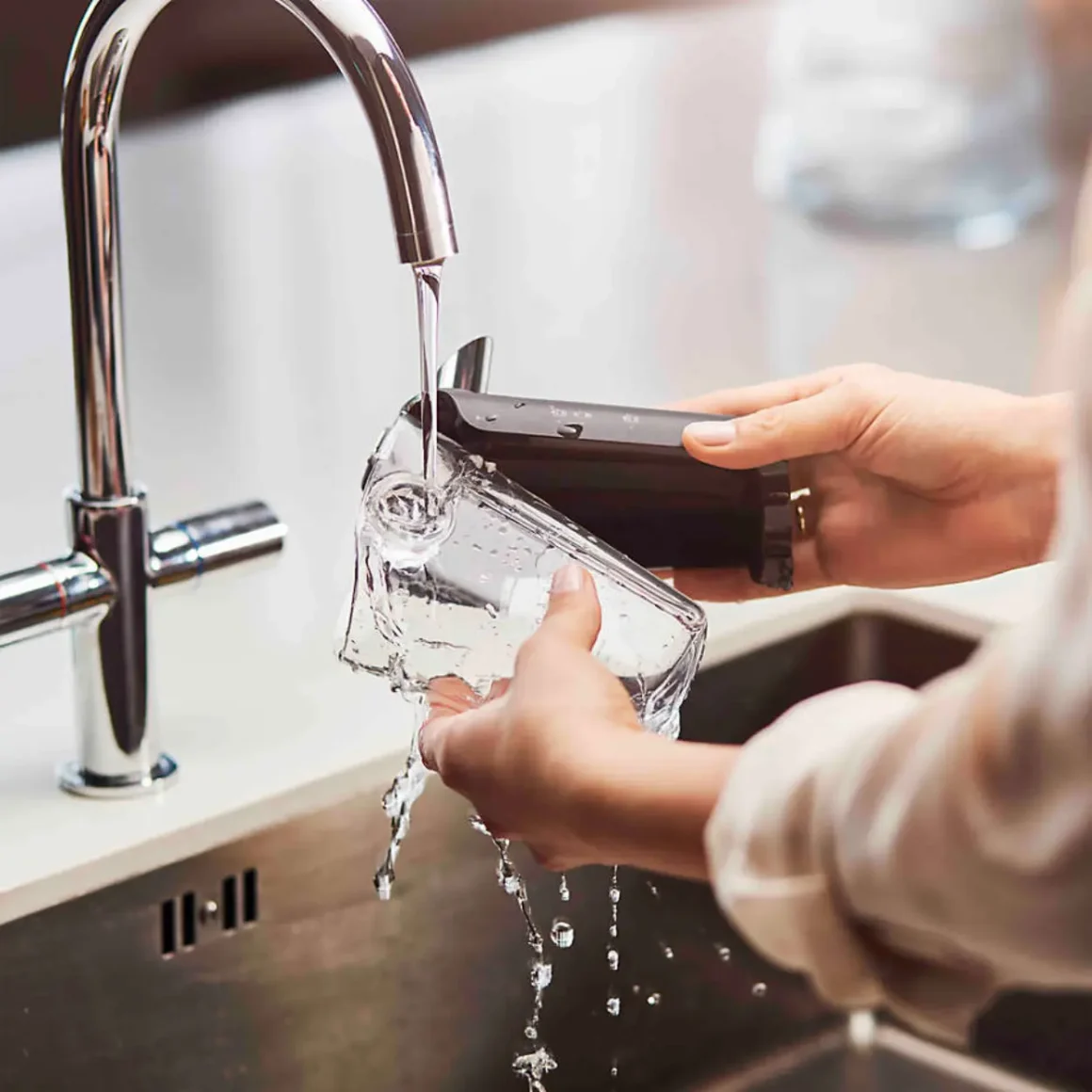 a person washing the LatteGo system