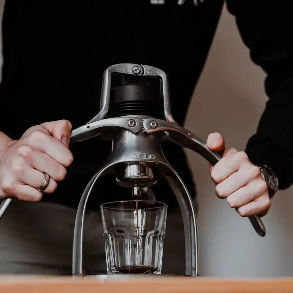 barista using a rok manual espresso machine