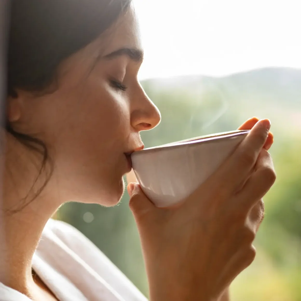 a person drinking blend coffee from a cup