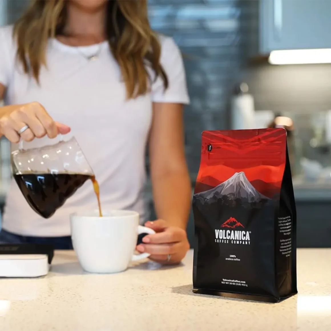 a person pouring coffee into a cup