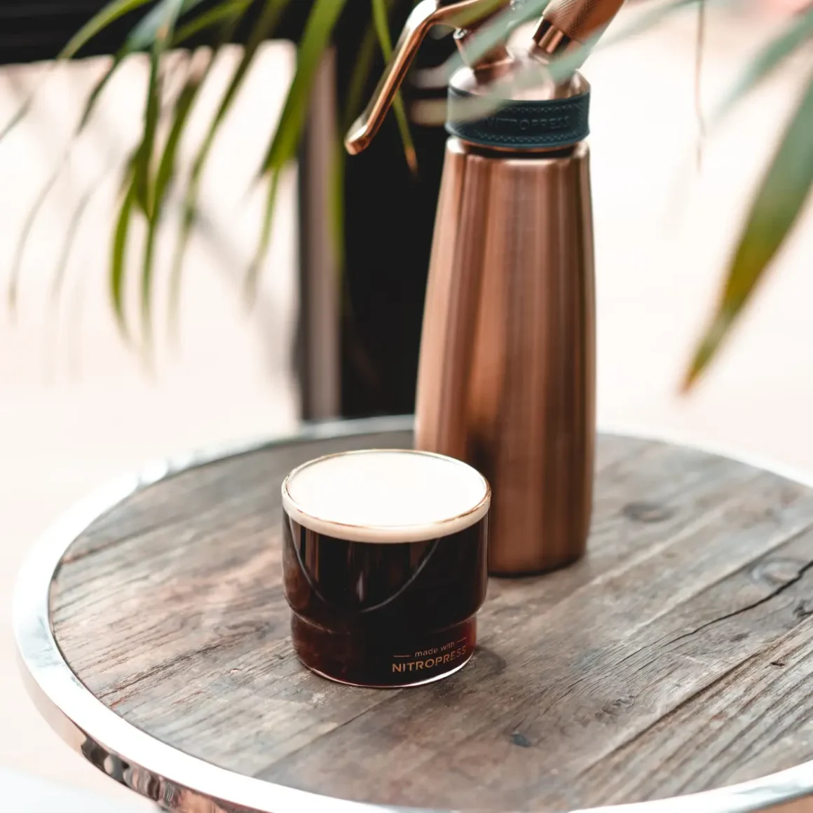 a glass of nitro coffee on a table
