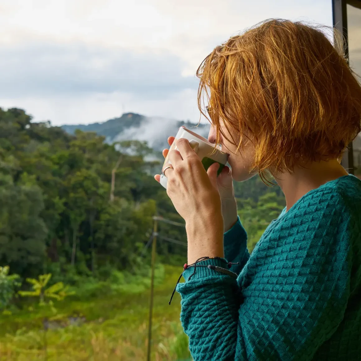 a person drinking single origin coffee from a cup