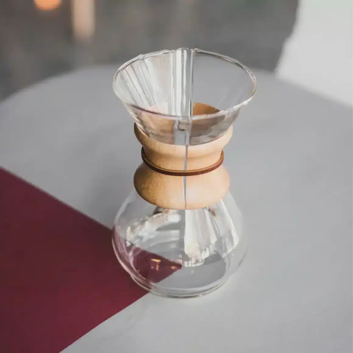 a glass container with a wooden handle