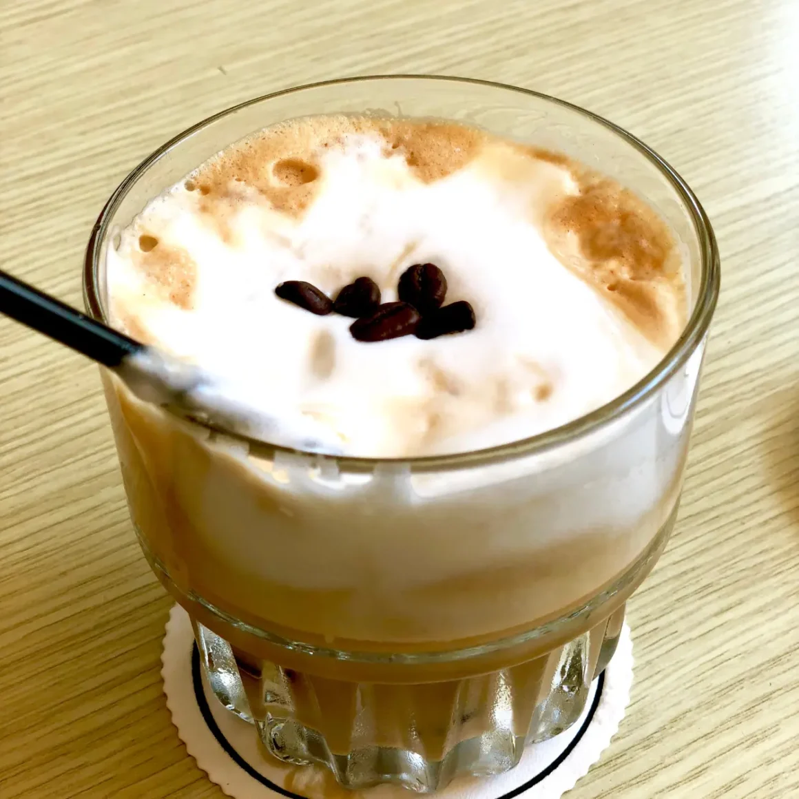 a glass of freddo cappuccino with a spoon