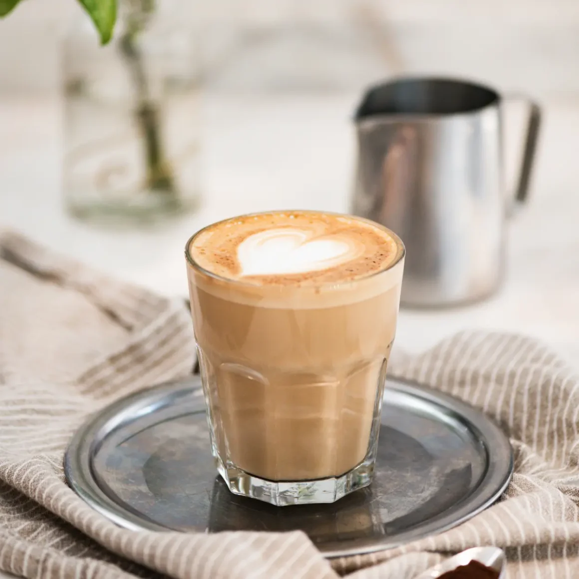 a glass of coffee on a tray