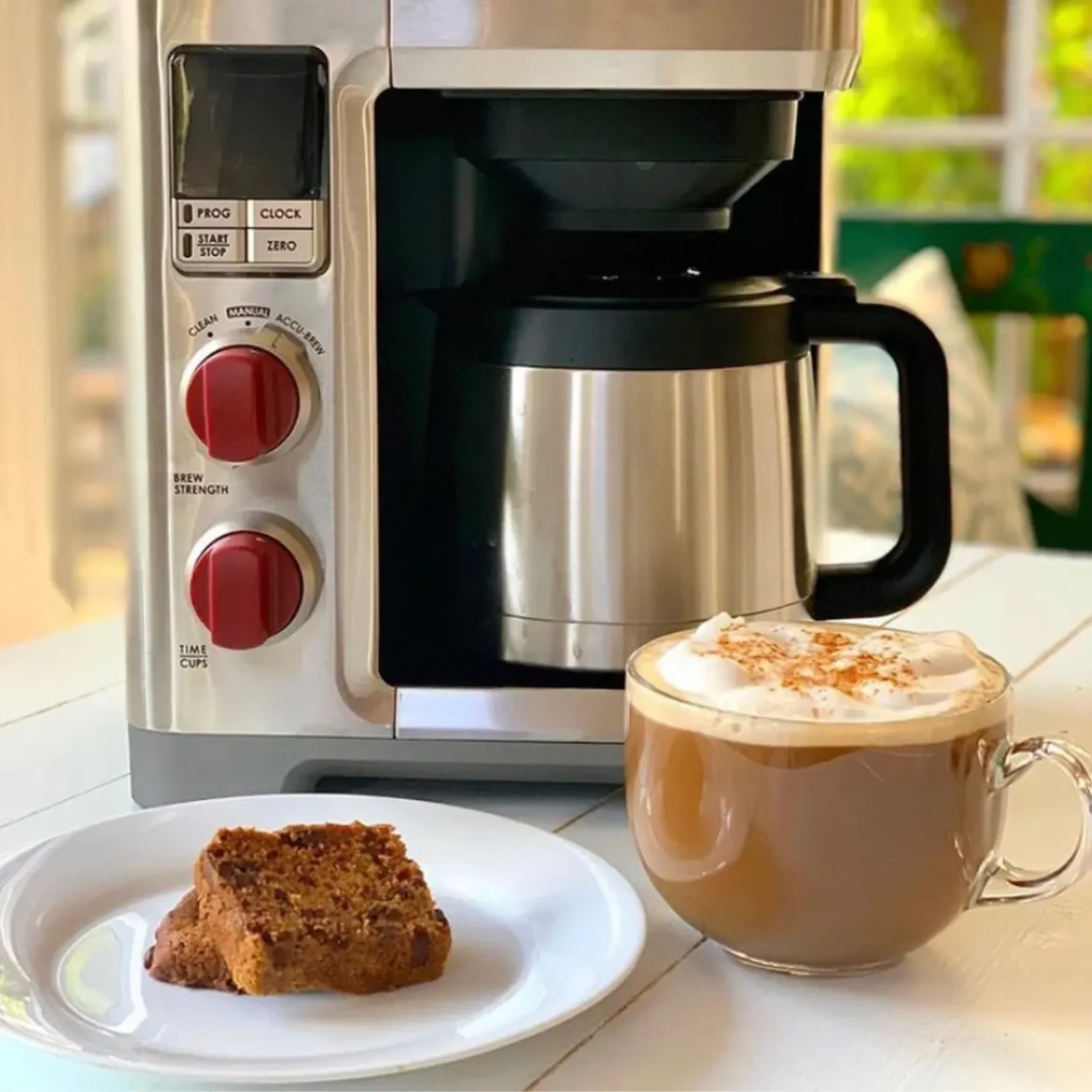 a wolf gourmet 10 cup coffee maker and a cup of coffee