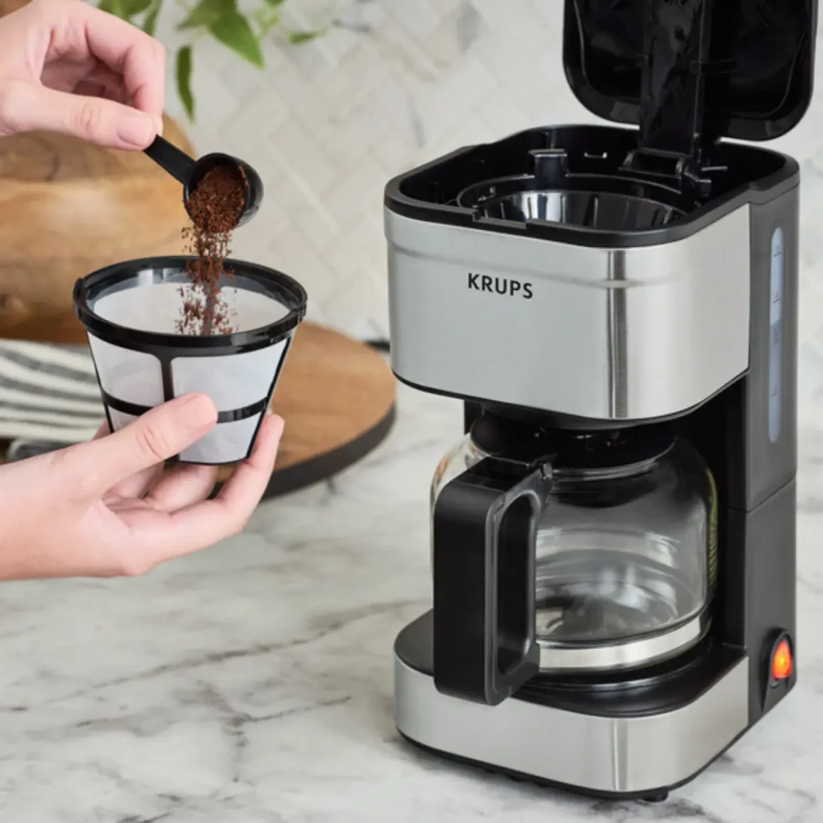 a person pouring coffee into a filter
