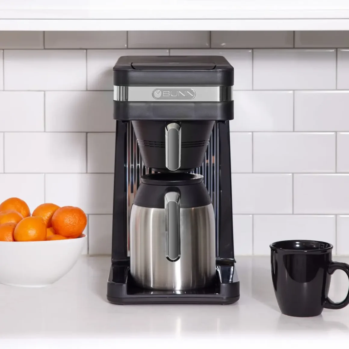 a bunn 55200 CSB3T coffee maker and a bowl of oranges on a counter