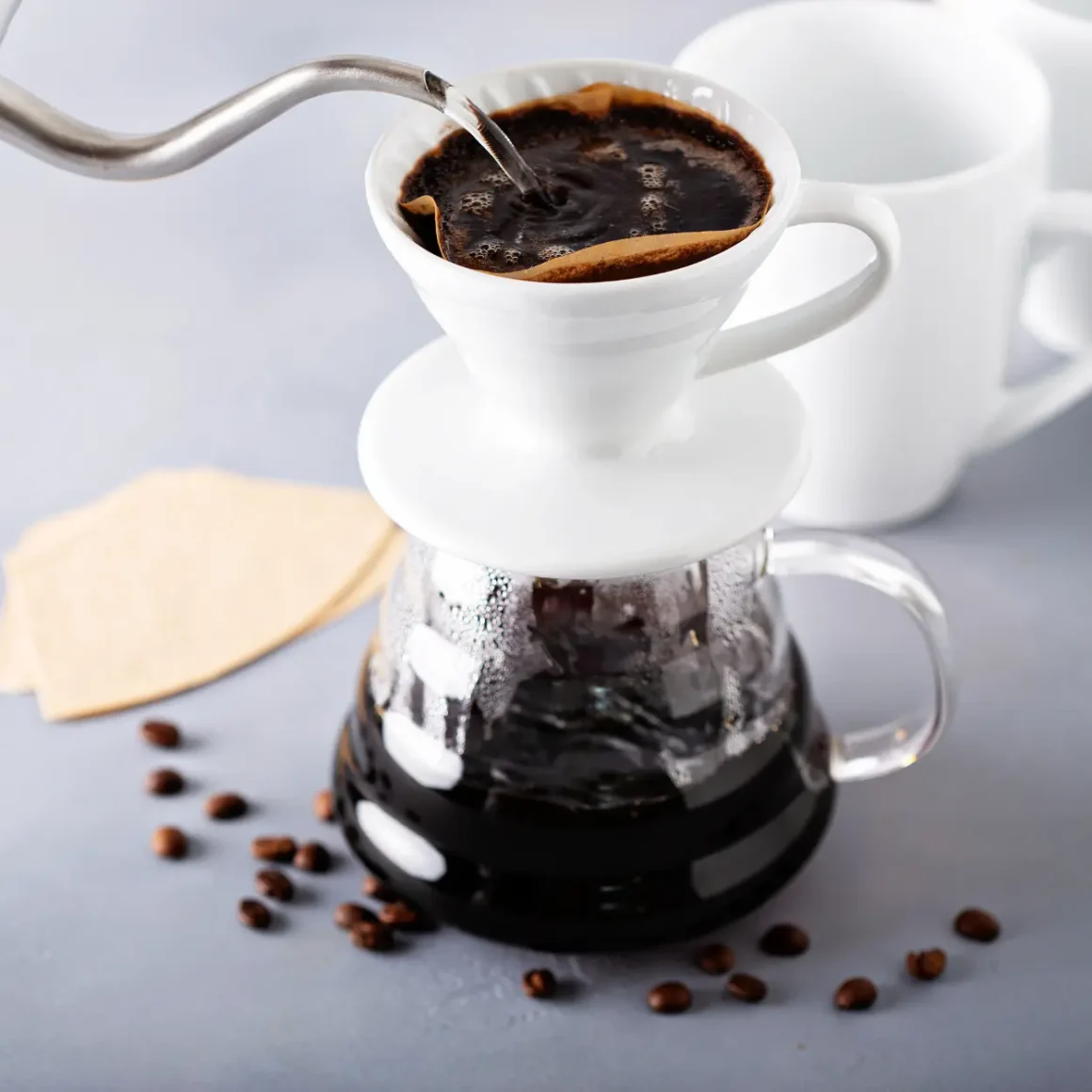 barista brewing coffee in a coffee maker