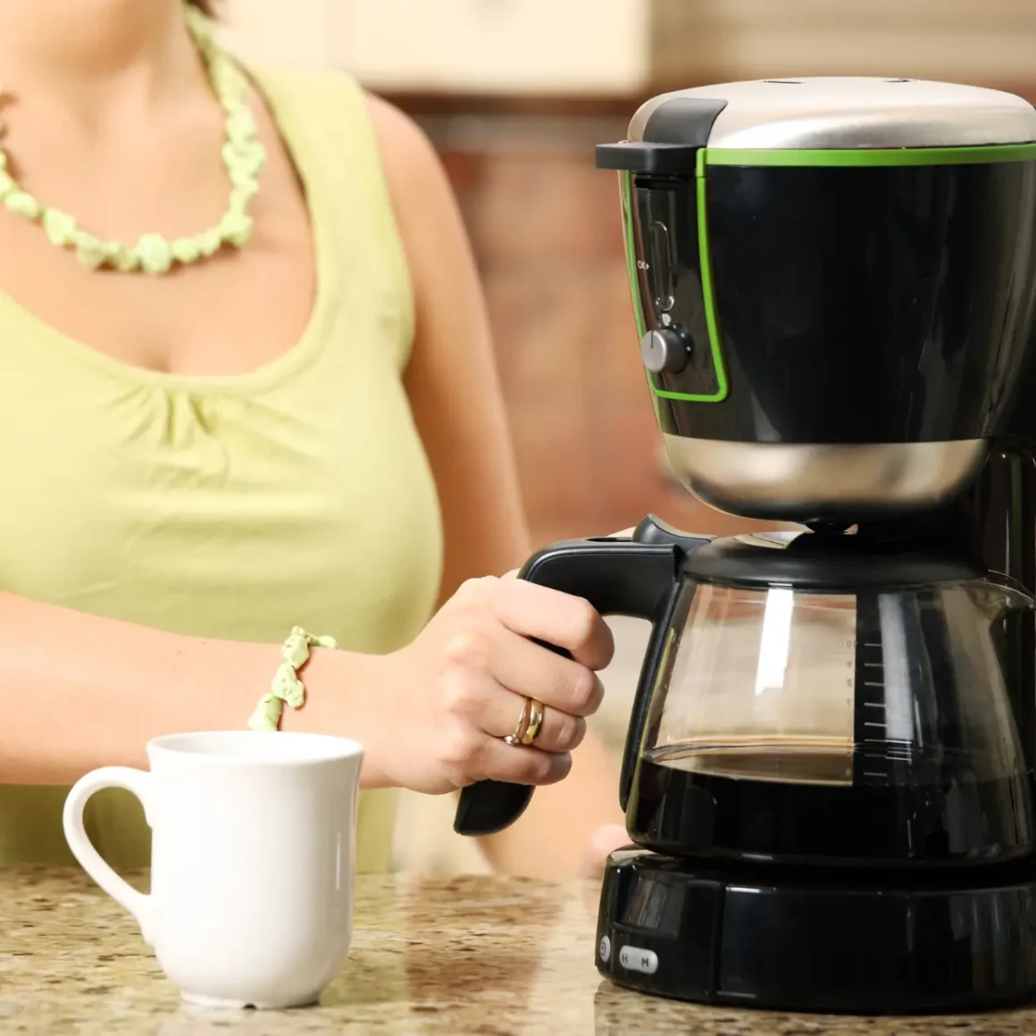 barista brewing caffe misto using a coffee maker