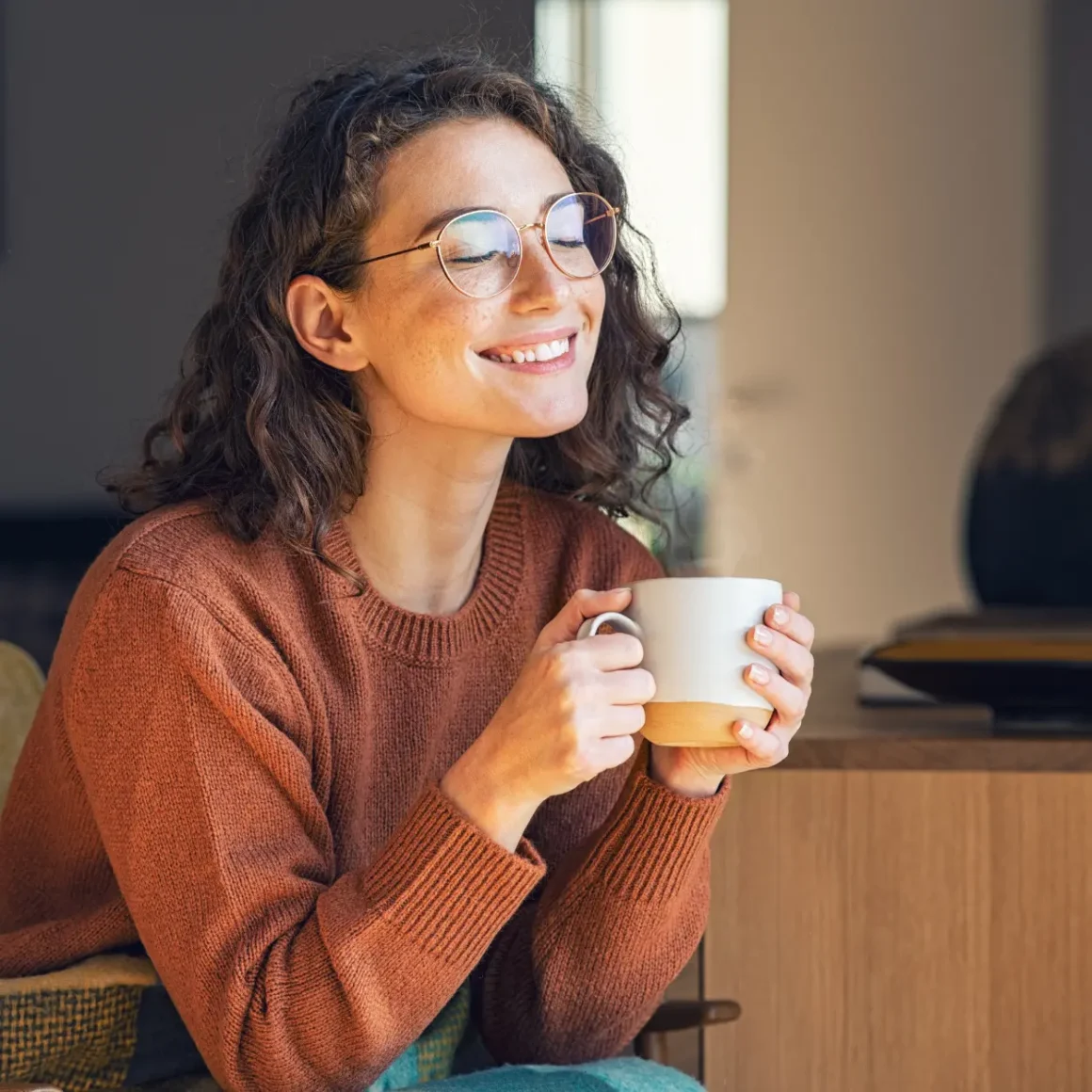 a woman holding a cup of caffe misto