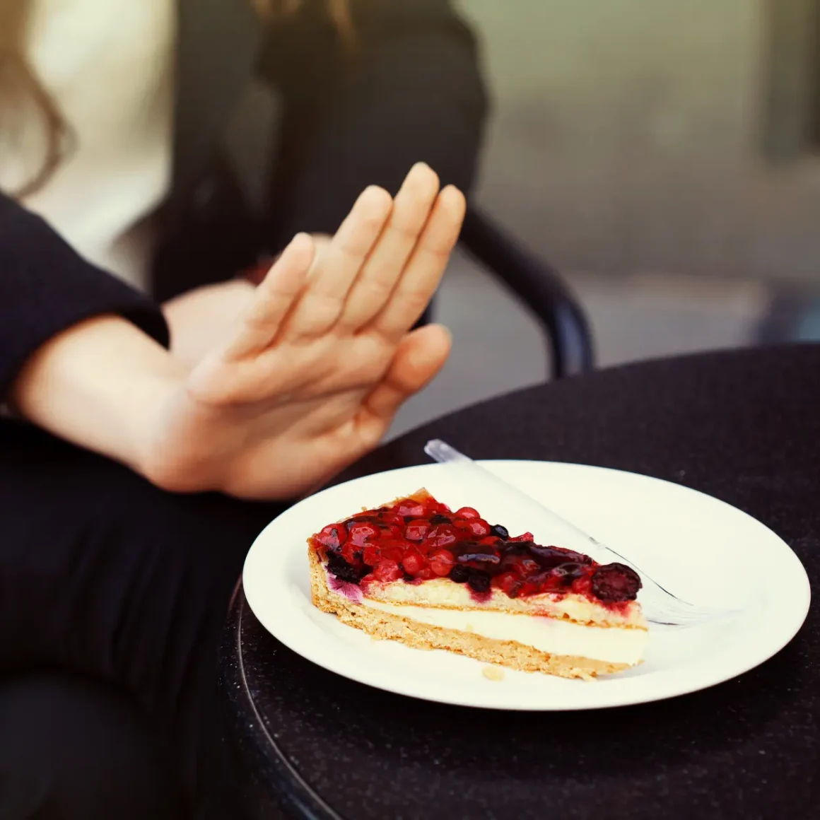 a hand holding a plate of food