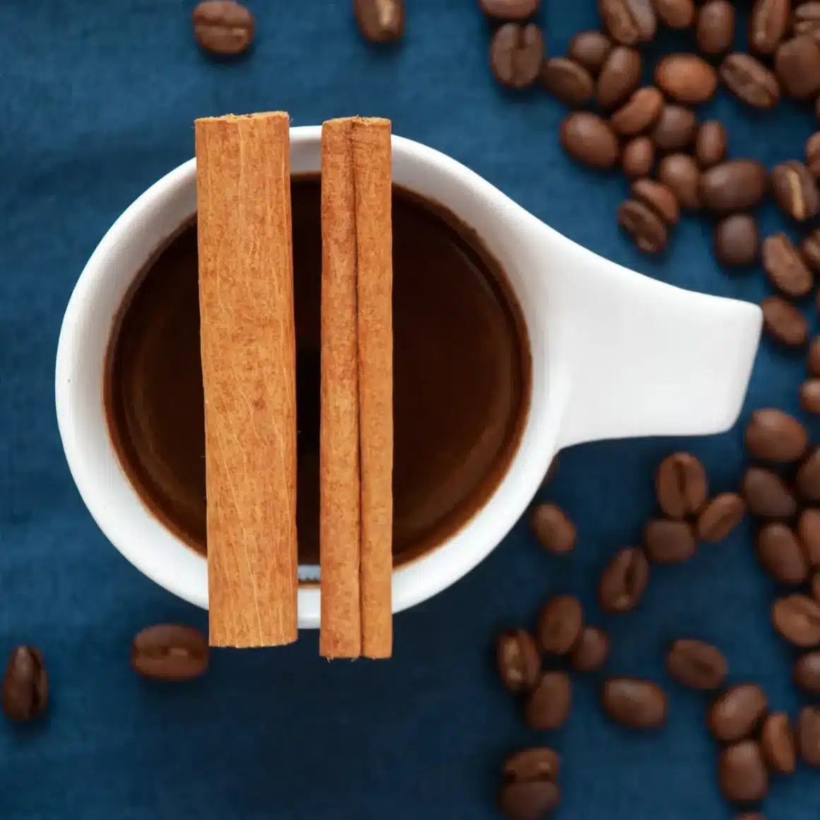 a cup of coffee with cinnamon sticks