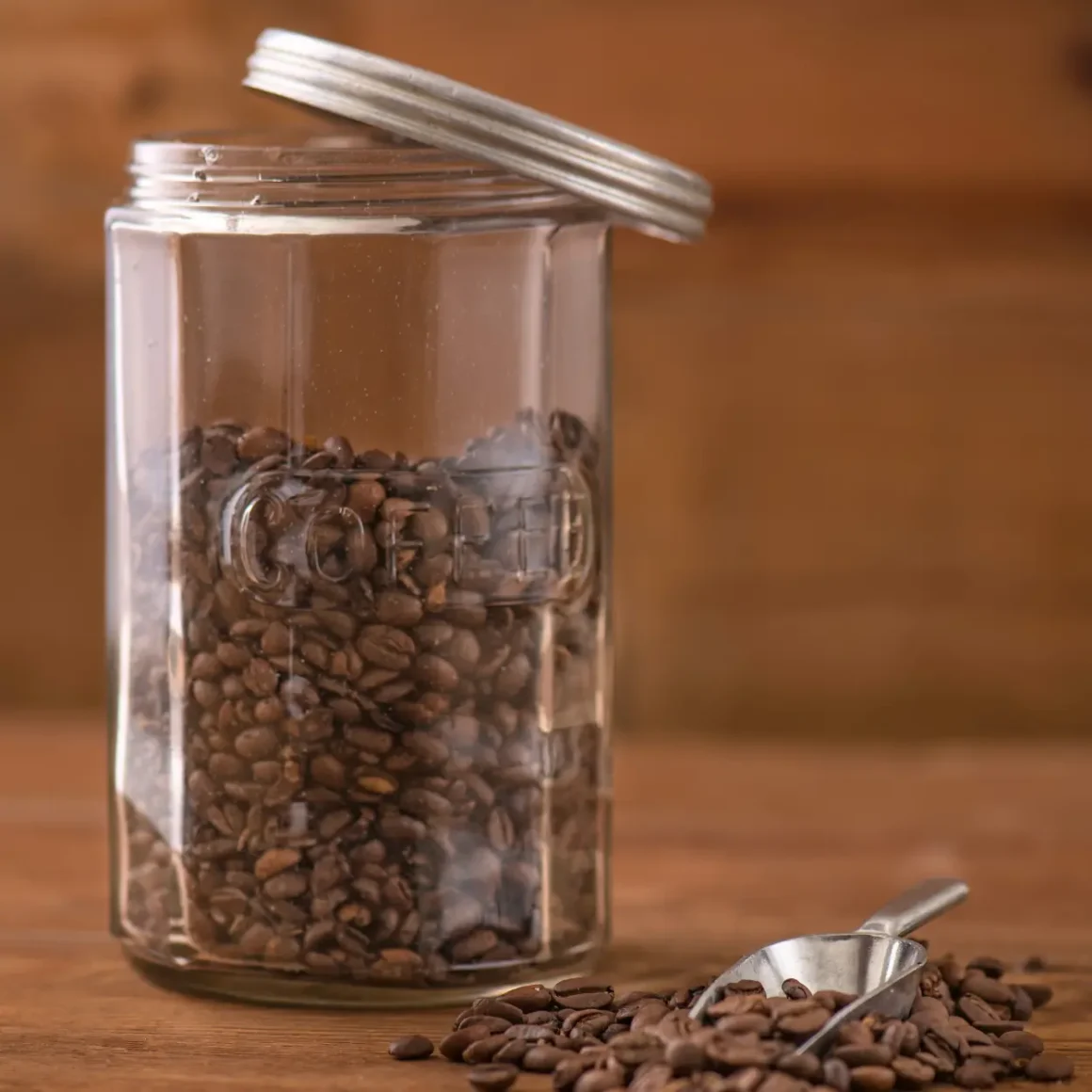 a fellow atmos vacuum canister with coffee beans and a spoon