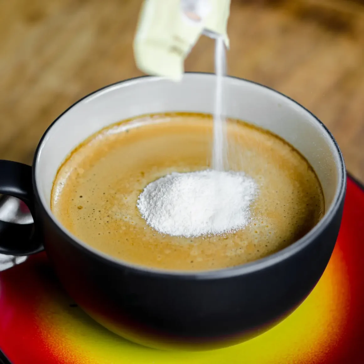 a cup of coffee with a creamer in it