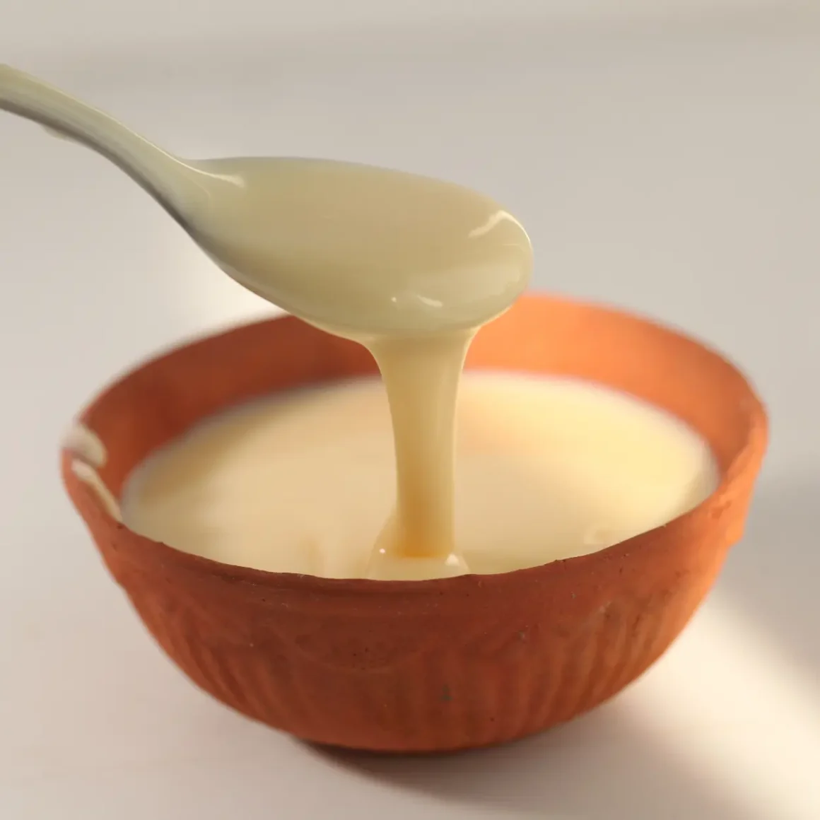 a spoon condensed milk into a bowl