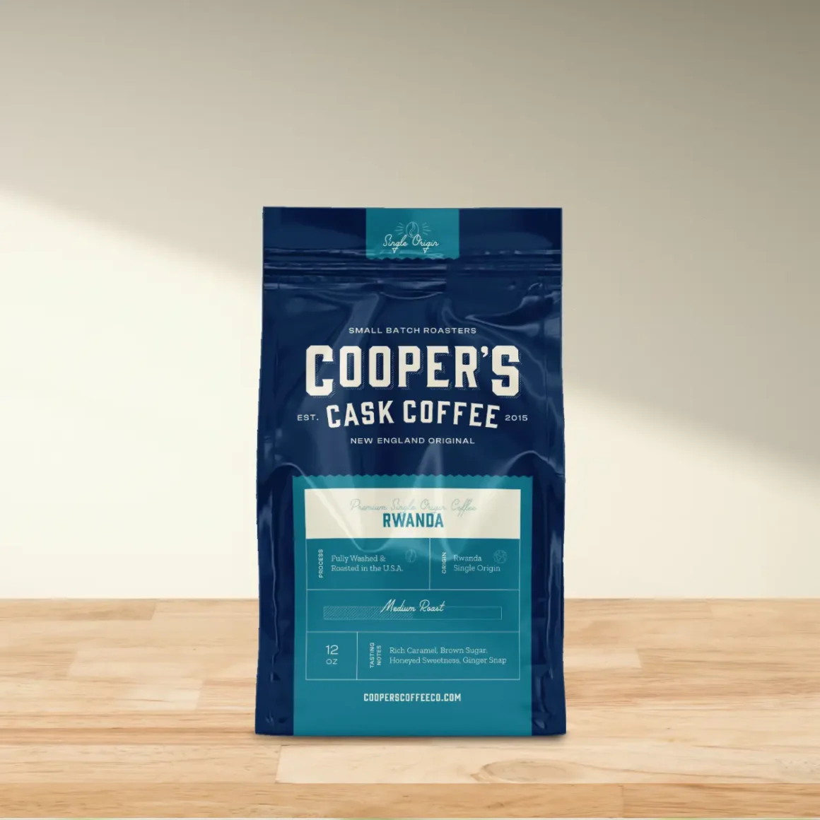a blue bag of coopers cask medium roast coffee on a wooden surface