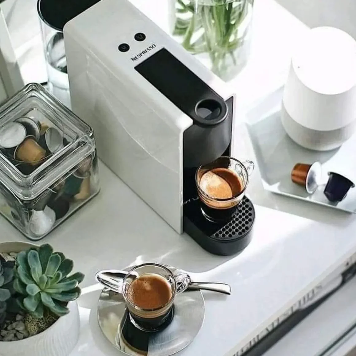 a nespresso essenza mini espresso machine by breville on a table