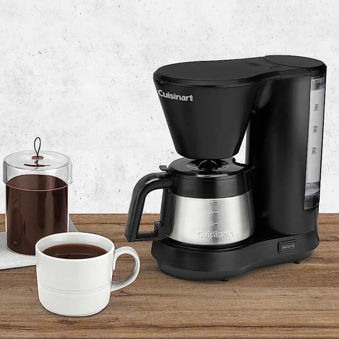 a cuisinart dcc-5570 5-cup coffee maker and a cup of coffee