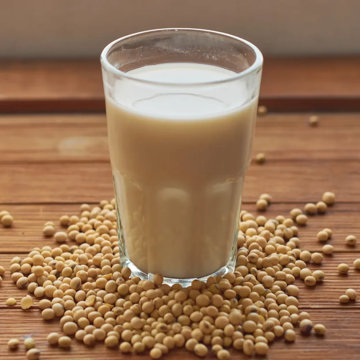 a glass of macchiato coffee and soybeans on a table