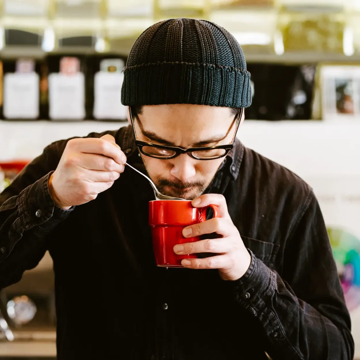 a man holding a red cup of coffee