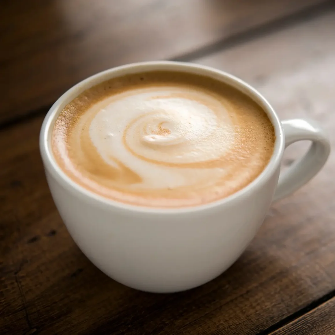 a cup dry cappuccino with a swirl in the foam