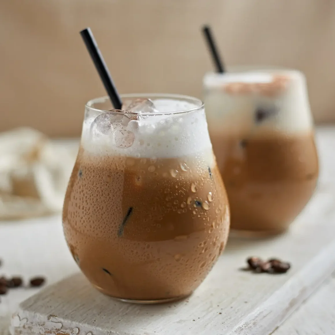 two glasses of iced cortado coffee