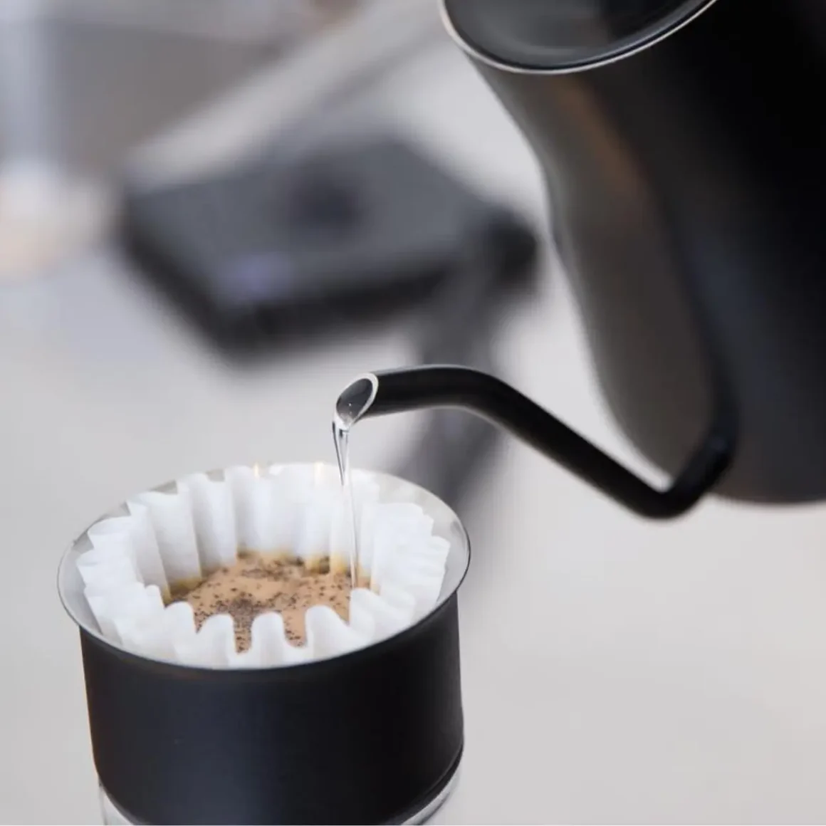 an electric kettle pouring water into a filter