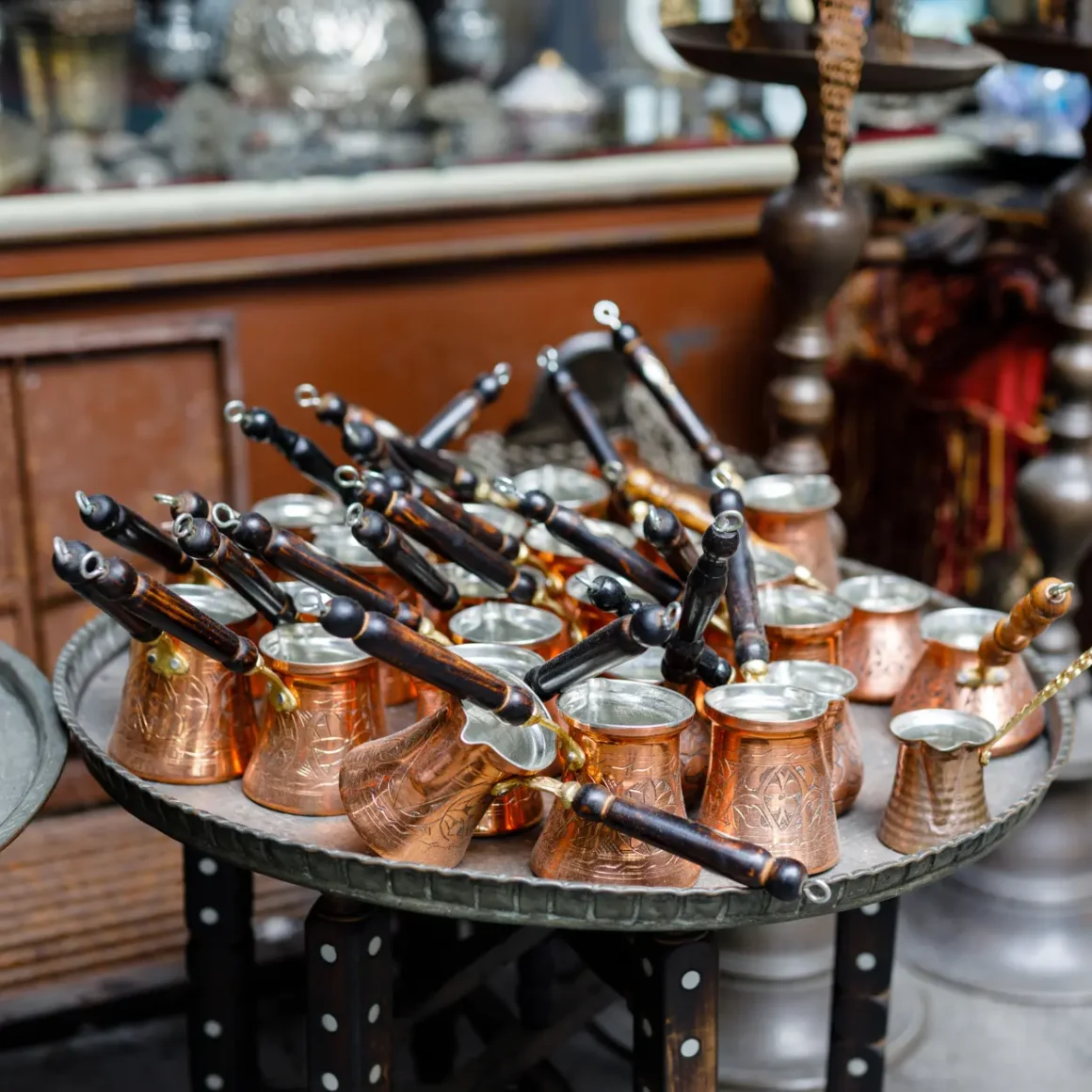 a group of copper pots on a table