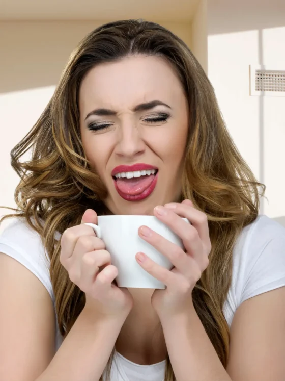 a woman holding a white mug