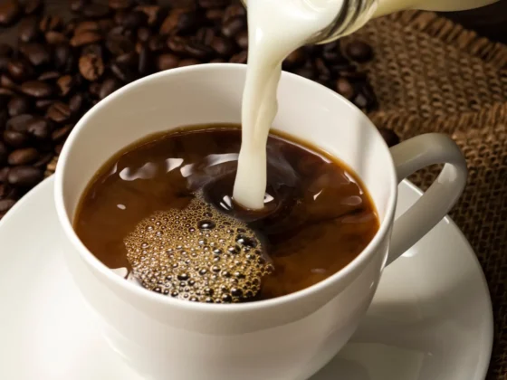 butter being poured into a cup of coffee