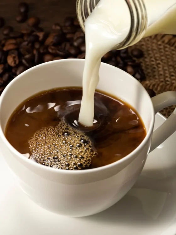 butter being poured into a cup of coffee