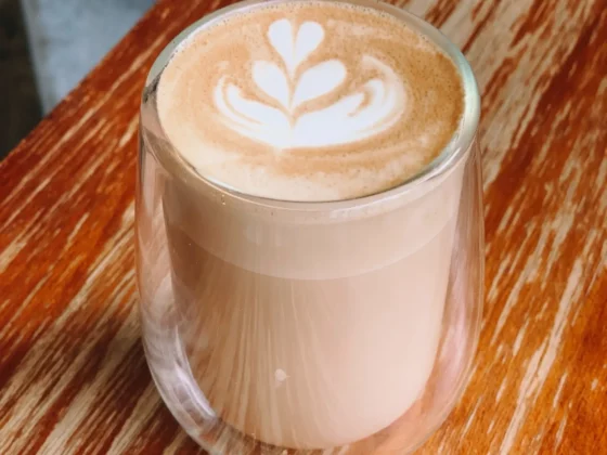 a glass cup of caffe misto with a leaf design on top