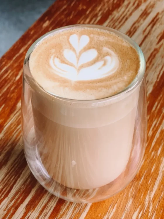 a glass cup of caffe misto with a leaf design on top