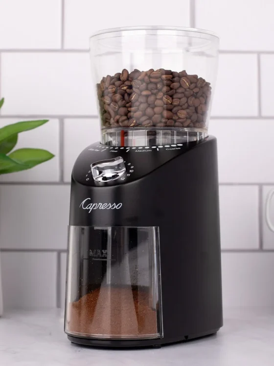 a capresso infinity coffee grinder with beans in it